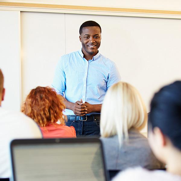 Aftican American male teaching in classroom