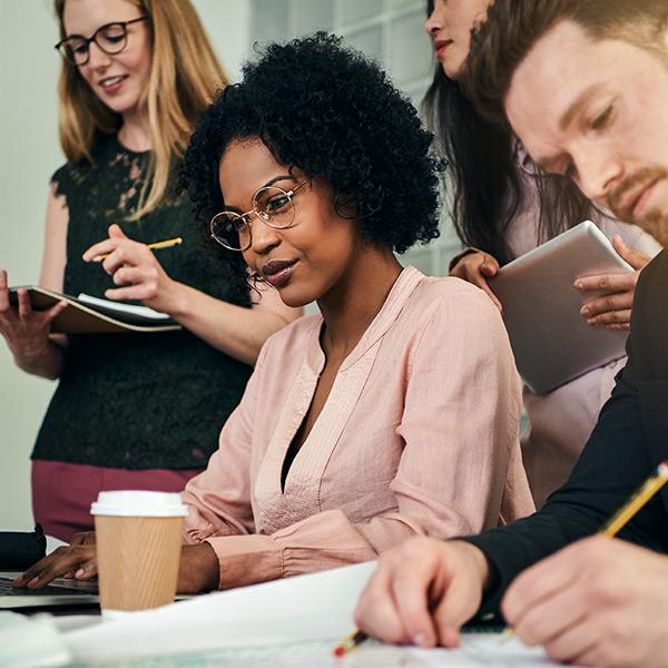 African American businesswoman and colleagues working together in an office